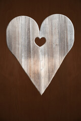 wooden heart shape on dark brown wood background