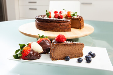 Homemade Strawberry Chocolate Cheesecake with one slice cut in the foreground. Culinary photography. selective focus