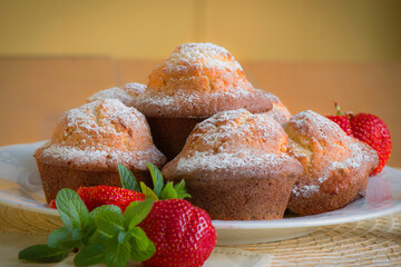 muffin with chocolate, powdered sugar, strawberries and green mint