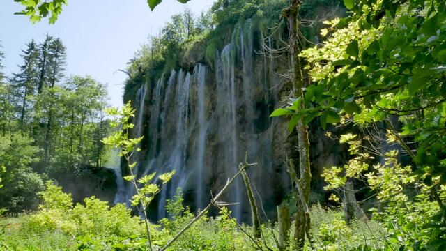 Large waterfall in the Plitvice Lakes National Park in Croatia. The Korana River, caused travertine barriers to form natural dams, which created a number of picturesque lakes, waterfalls and caves