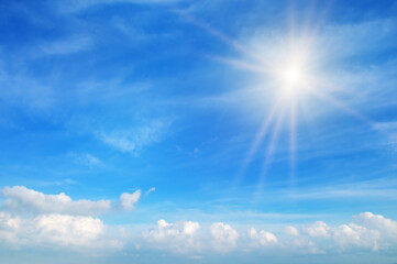 Naklejka na ściany i meble Beautiful, blue summer sky with fluffy clouds and bright sun .