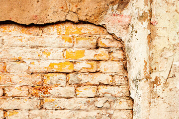 Texture of a brick wall with cracks and scratches which can be used as a background