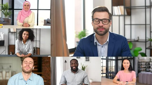 Confident caucasian male leader holding online video meeting with diverse work team, a lot of multiracial people on the screen talking together during online conference, work on the distance