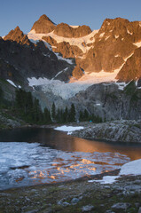 USA, Washington State. Mount Shuksan seen from partially frozen Lake Ann, Mount Baker Wilderness, North Cascades.