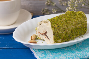 Eastern sweet chocolate halva with pistachios on a wooden table