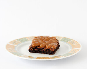 Chocolate brownie topped with cooked milk 