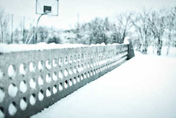 closeup of table tennis top covered with snow; table tennis net with snow, table tennis board net,...