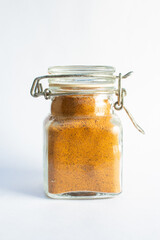 turmeric in a small spice jar isolated