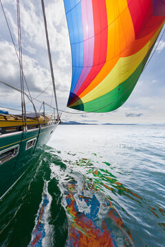 USA, Washington, San Juan Islands. View of SV Nawalk with spinnaker flying.