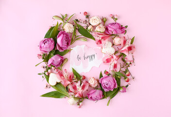Card "Be happy" on pink background with flower frame.