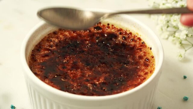 Broken, cracked crust. Creme brulee. Traditional French vanilla dessert with burned cream. Spanish crema catalana, rich custard base topped with layer of hardened caramelized sugar