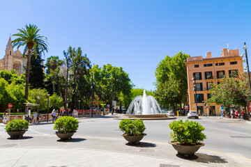 Plaza de la Reina, Boulevard Passeig del Born roundabout water fountain junction near the La Seu Cathedral and Almudaina Palace gardens in Palma Mallorca.