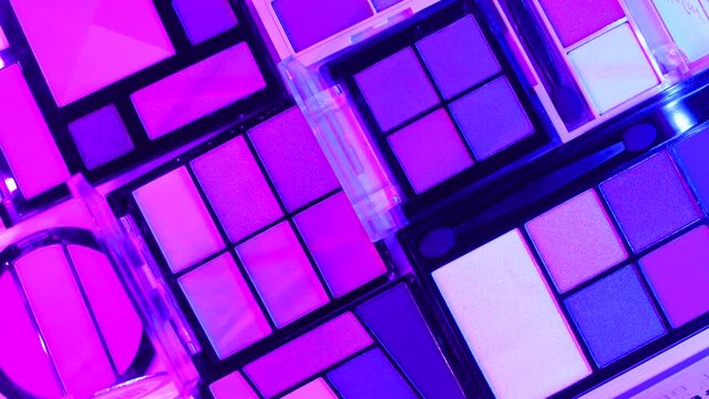 Make up eye shadow palettes with sci fi cyber punk light effects. Flat lay 