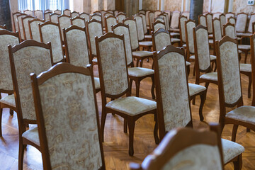 Rows of old, vintage chairs. Auditorium room. Rays of sunlight through the window. Training, meeting and business concept. selective focus. Copy space