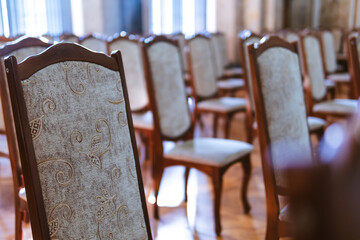 Rows of old, vintage chairs. Auditorium room. Rays of sunlight through the window. Training, meeting and business concept. selective focus. Copy space