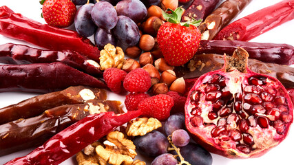 Churchkhela mix, fruits, berries and nuts on a white table, food background, Caucasian sweets