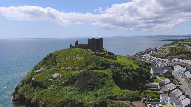 Welsh Coastal Castle on the Llyn Peninsula, North Wales. Aerial Reveal shot in 4k
