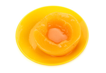 canning peaches isolated on blue plate.