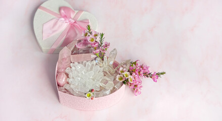 Gift box with clear and pink quartz minerals set and flowers. Healing minerals for Chakra...