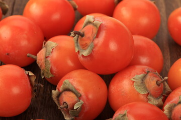 Fresh ripe persimmon on a wooden table