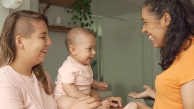 Lesbian Mother Playing With Peekaboo With Baby In The Kitchen
