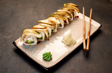Japanese sushi rolls on a stone background