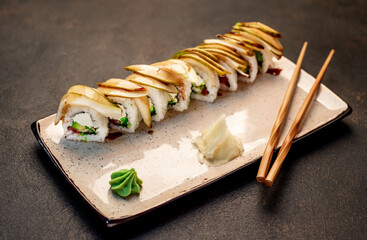 Japanese sushi rolls on a stone background