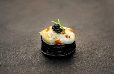 baked sushi rolls on a stone background