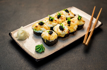 baked sushi rolls on a stone background