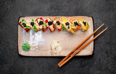 Japanese sushi rolls on a stone background	