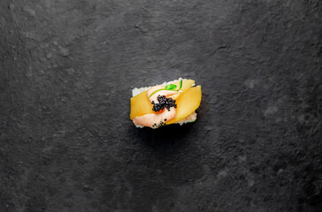 one sushi roll on a stone background