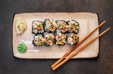 Japanese sushi rolls on a stone background