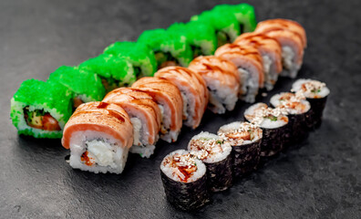 Assorted sushi. set of sushi rolls and nigiri on a stone background