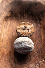 dry brown nutmeg on red wood