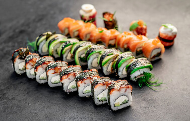 Assorted sushi. set of sushi rolls and nigiri on a stone background