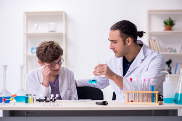 Young father and son chemists in the lab