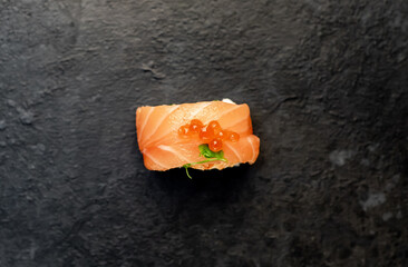 one sushi roll on a stone background