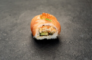 one sushi roll on a stone background