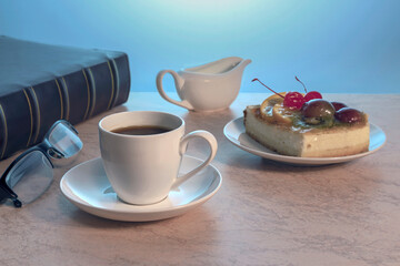a cup of strong black coffee and a piece of delicious homemade cake on a plate on a wooden table