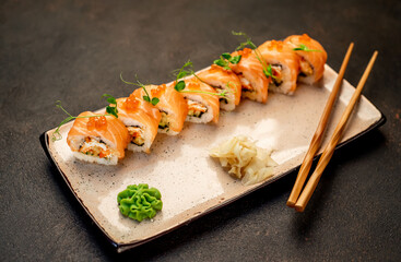  Japanese sushi rolls on a stone background