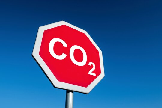 Stop traffic sign demanding the CO2 carbon dioxide emmisions from industry to be lower and save our environment