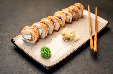 Japanese sushi rolls on a stone background	