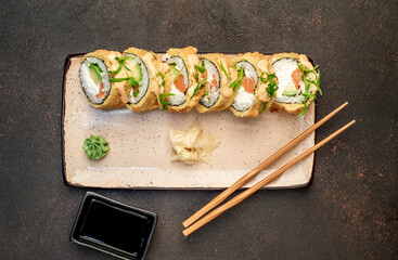 baked sushi rolls on a stone background