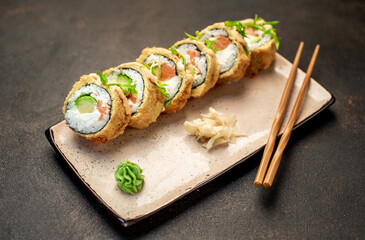 baked sushi rolls on a stone background