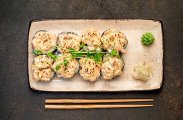 baked sushi rolls on a stone background