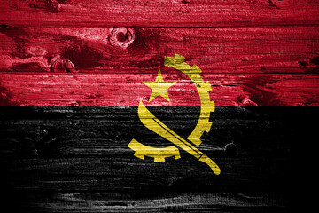 Angola flag on wooden planks background