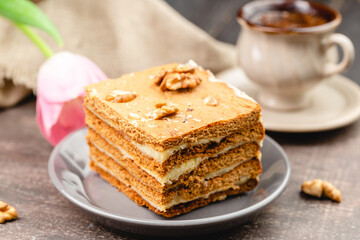 Slice of layered honey cake selective focus