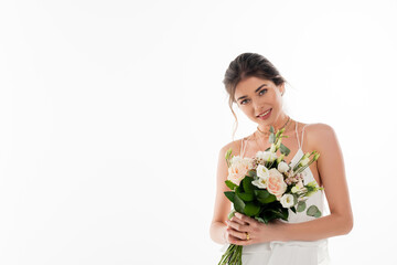 smiling bride with wedding bouquet looking at camera isolated on white