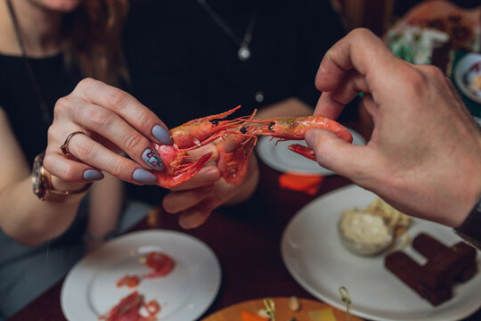 Shrimp with tomatoes and feta cheese on a plate on a table close-up. horizontal.