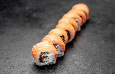 Japanese sushi rolls on a stone background